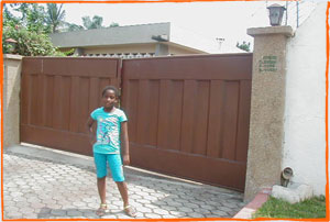 Yahan steps out of her uncle's home in Abelemkpe, Accra