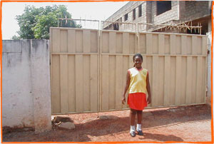 Wendy in front of a relative's home in Abelemkpe